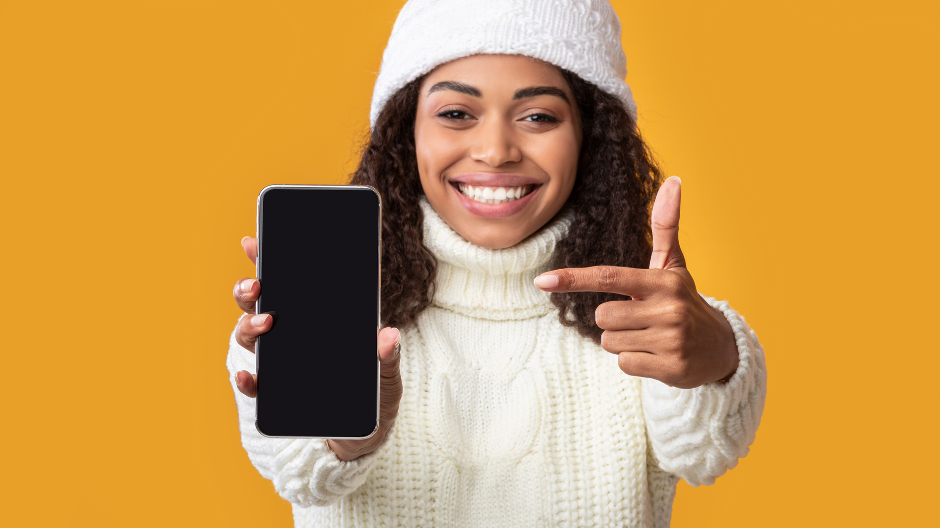 African american woman showing blank cell phone screen